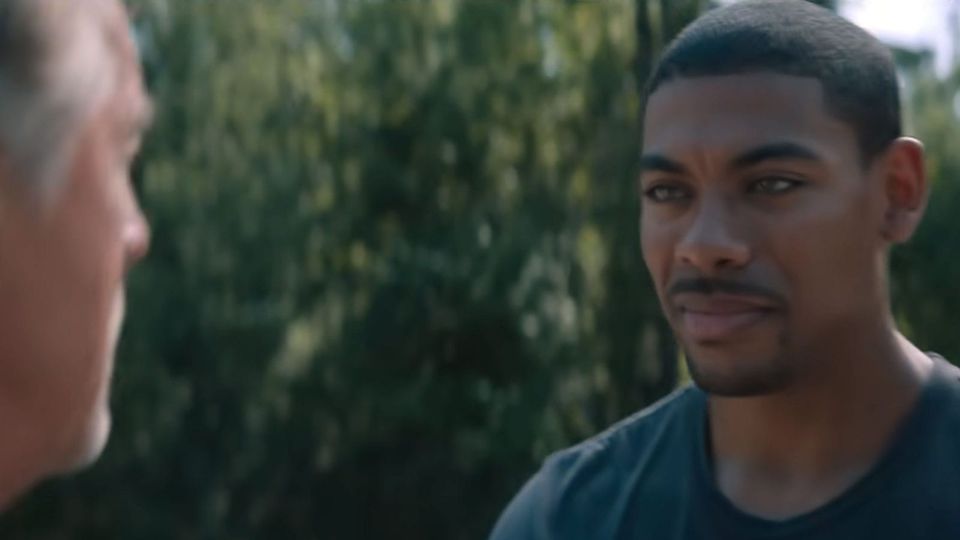 A Black man in a trim goatee and short hair faces off against a gray-haired White man in 'Rebel Ridge'