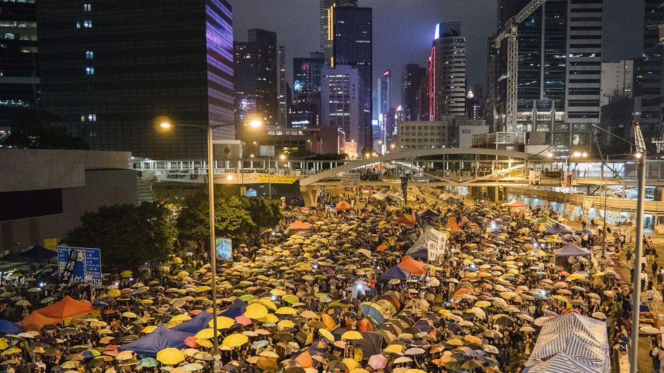 A large crowd of Hong Kongers held their umbrellas while singing a song under clear sky in Harcourt Road, October 28, 2014