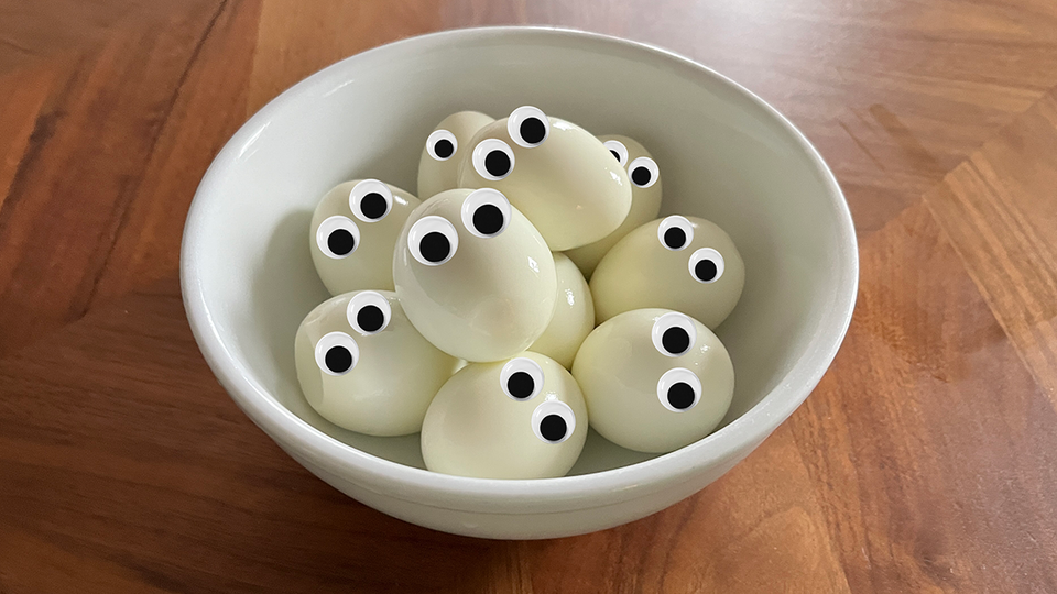 A bowl of eggs with googly eyes
