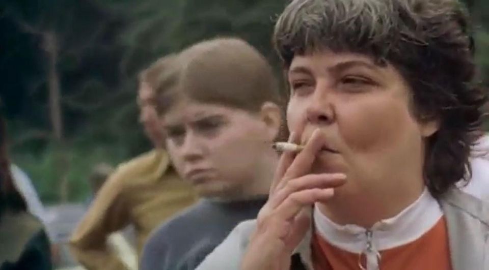 Screenshot from 'Harlan County, USA' shows a woman smoking a cigarette with a fiercely determined expression