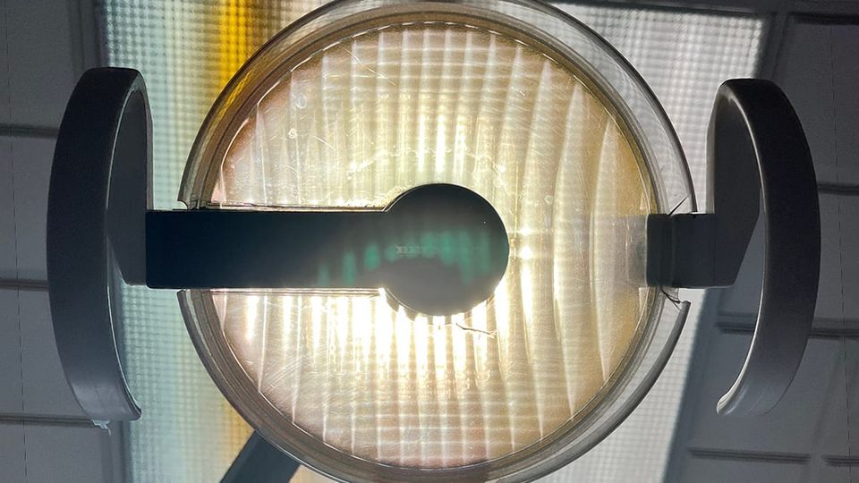 An examination light as viewed from chair at dentist's office.