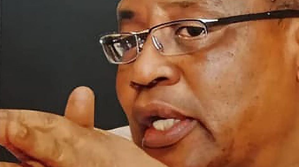 Image of bespectacled Babangida shows him touching his fingers together 