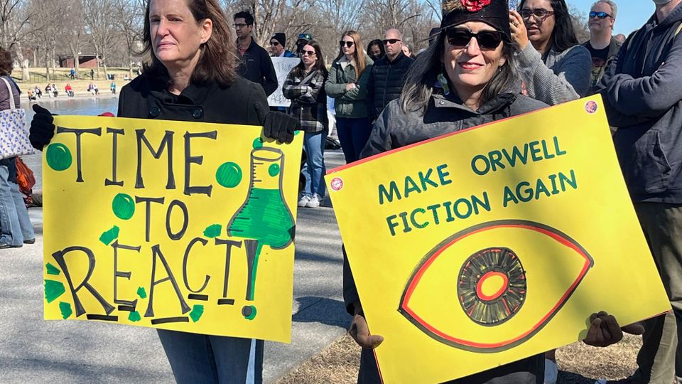 Signs at the March 7, 2025 Stand Up for Science Demonstration at the Lincoln Memorial read: TIME TO REACT! and MAKE ORWELL FICTION AGAIN