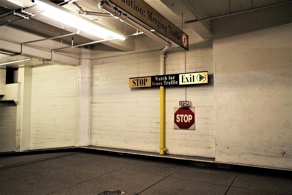 Interior parking garage signage, Caution: Merging Traffic STOP Watch for Cross Traffic Exit STOP STOP