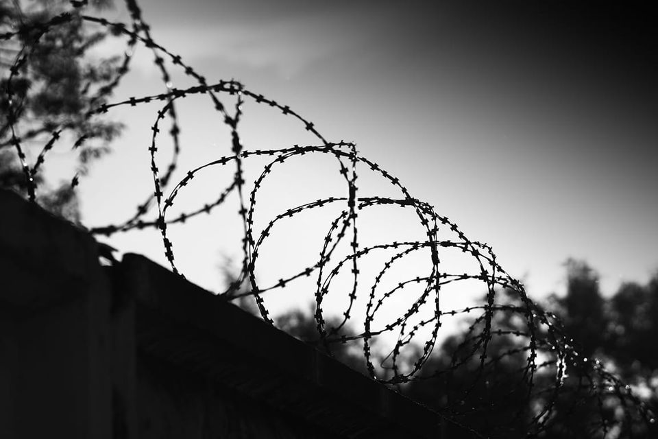Razor wire atop a confinement wall