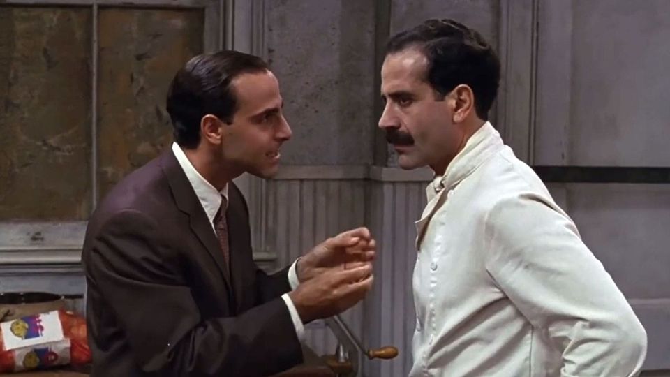 Stanley Tucci and Tony Shaloub in BIG NIGHT (1997); Tucci dressed in a brown suit, Shaloub in chef whites
