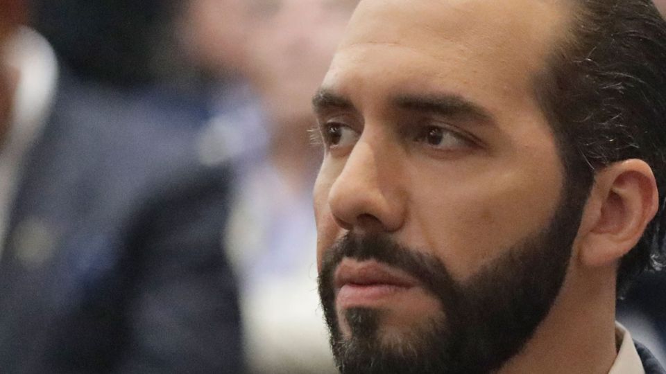A bearded Bukele at a public event with a coldly focused expression
