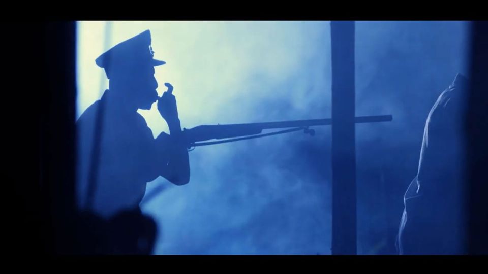 Screenshot of the trailer for 'October 1' shows a night scene of a uniformed man in silhouette, holding a rifle, blowing a whistle