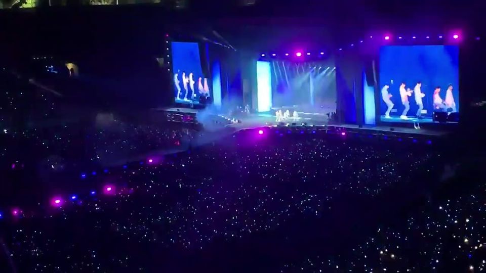 60,000 people in venue, darkness studded with light sticks, like a night sky