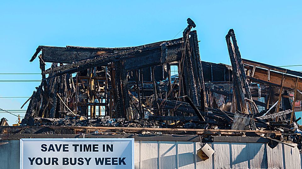 A store building damaged by fire sign remains SAVE TIME IN YOUR BUSY WEEK