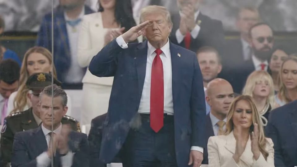 Miserable looking Donald Trump at his army tank birthday parade, flanked by equally miserable Melania Trump and Pete Hegseth