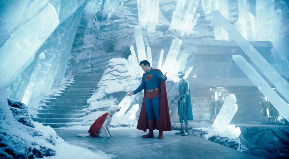 Superman with his dog, who also gets a cape, and the robot, who also-also gets a cape in the icy Fortress of Solitude