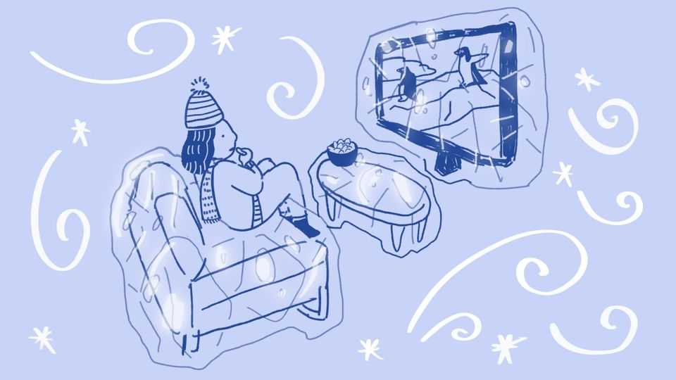 Ice-cold scene on the couch of the author in a wooly hat and scarf, watching penguins on TV