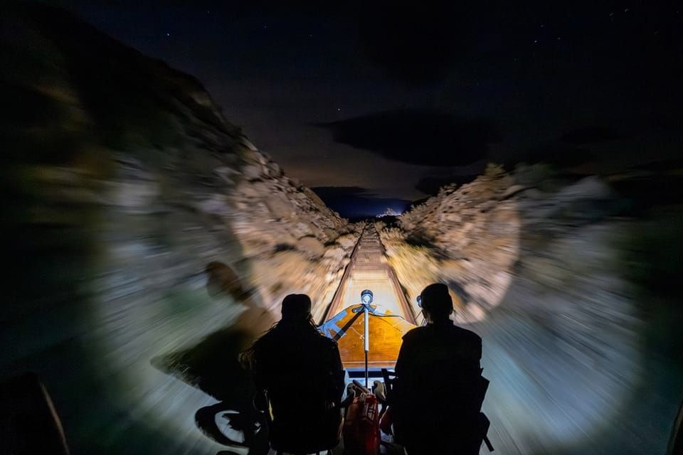 Whizzing through the desert on a hand-built train at night