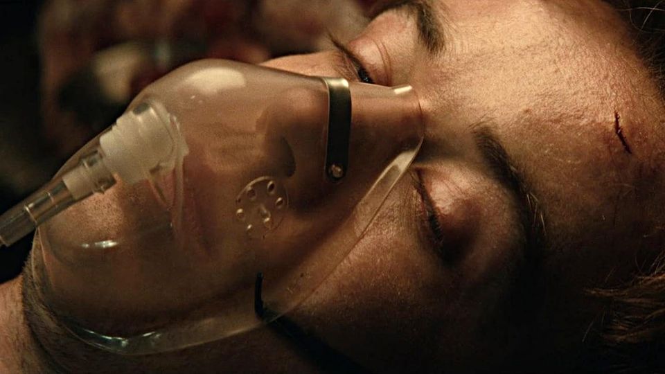 Lawther's character Joe Hermit semi-conscious wearing an oxygen mask