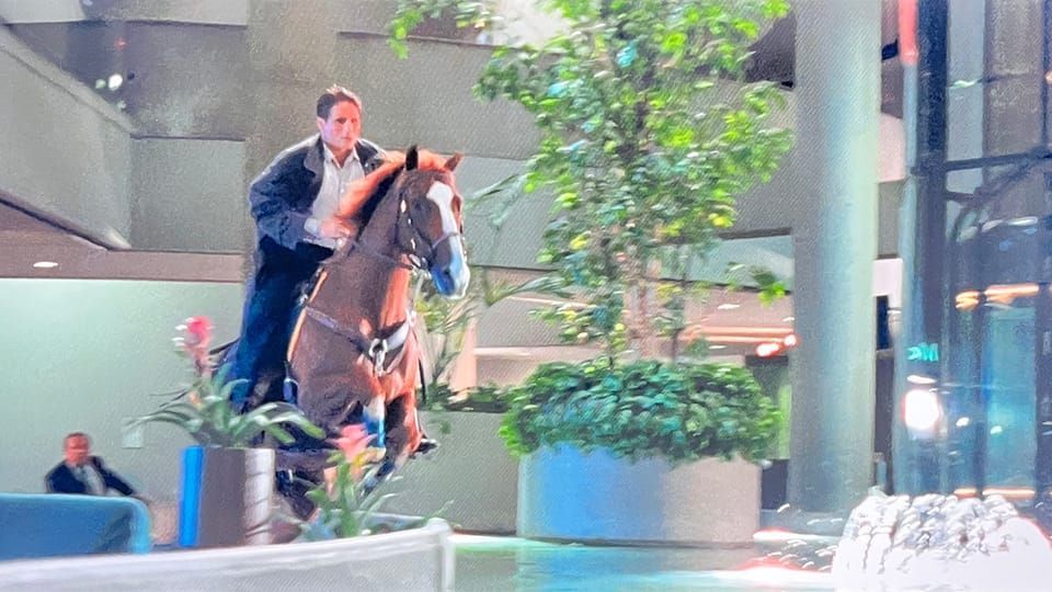 Arnold Schwarzenegger's stunt double rides a horse through the lobby of the Ambassador Hotel in Los Angeles in the film, 'True Lies'
