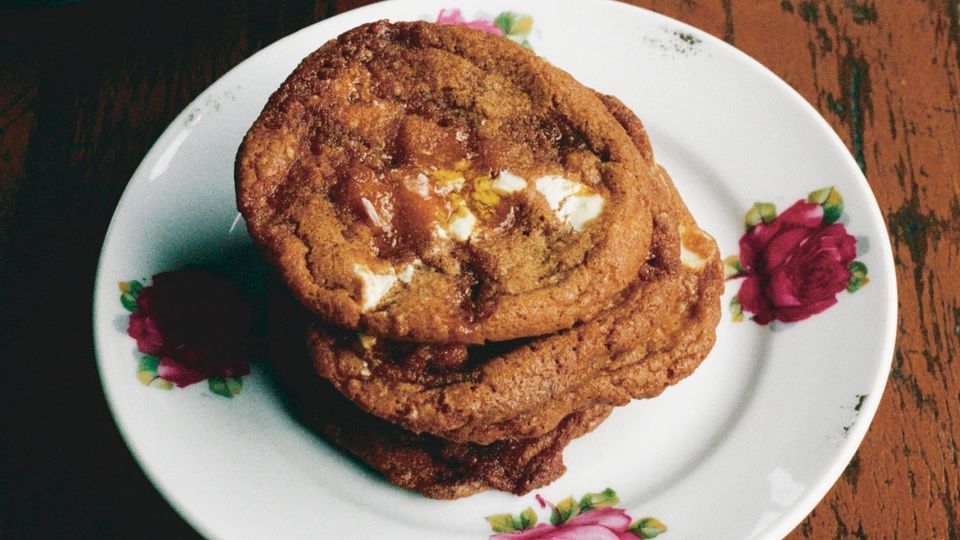 White Chocolate Burnt Caramel Cookies, looks like about 10,000 calories per each, stacked on a lovely plate with rose print