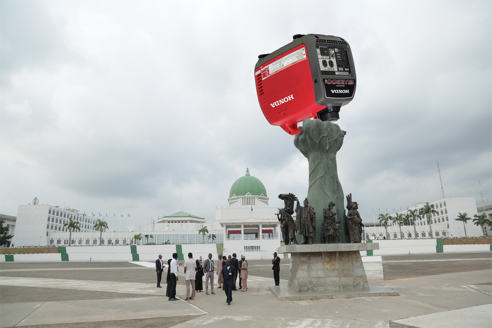 Sculpture at the National Assembly in Abuja holding a giant generator 