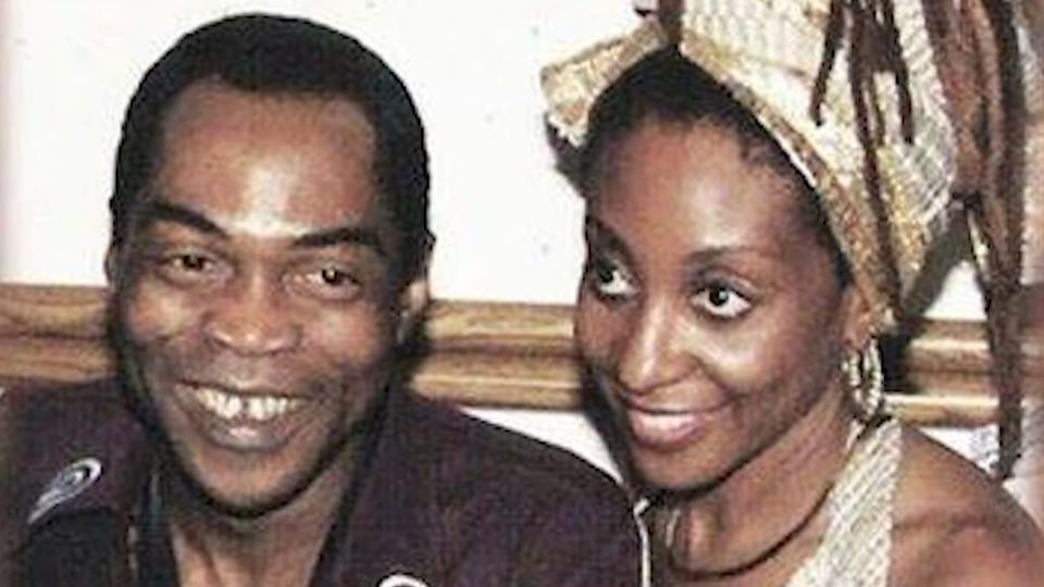 A young Sandra Izsadore poses with Fẹlá Kútì; both are smiling, beautiful, 10x alive