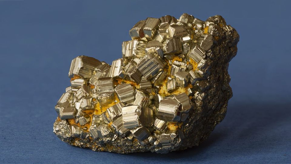 A chunk of glittering fool's gold on a blue ground