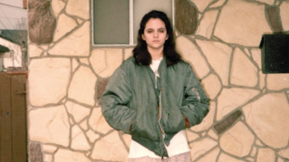 Wendy C. Ortiz as a teenager posing before a house faced in mosaic stone in the San Fernando Valley, Southern California