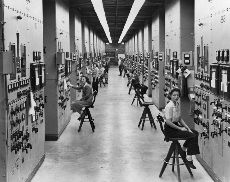 Calutron operators at their panels, in the Y-12 plant