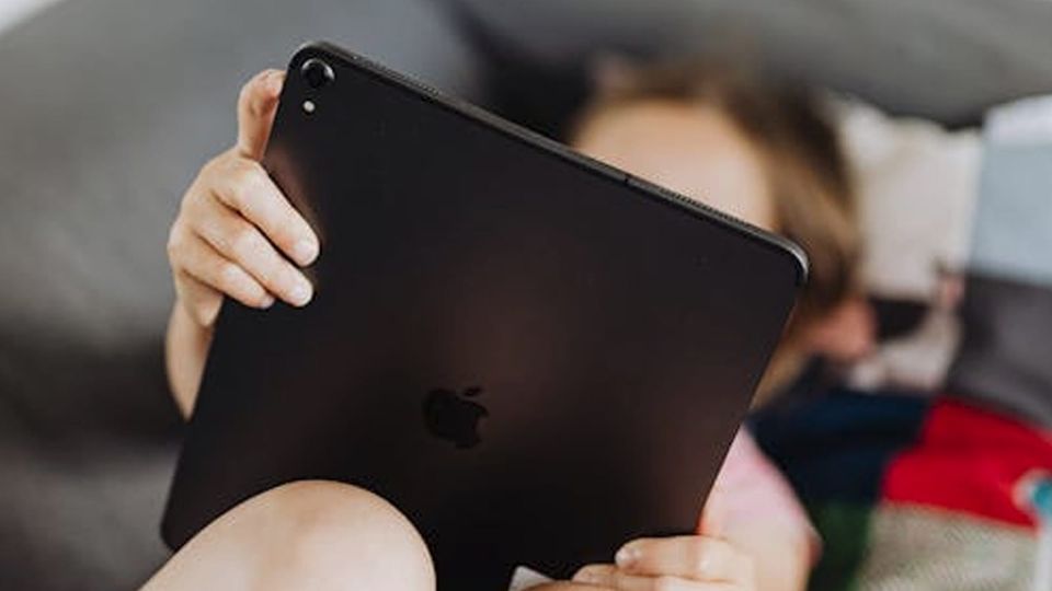 Person reclining and viewing an iPad