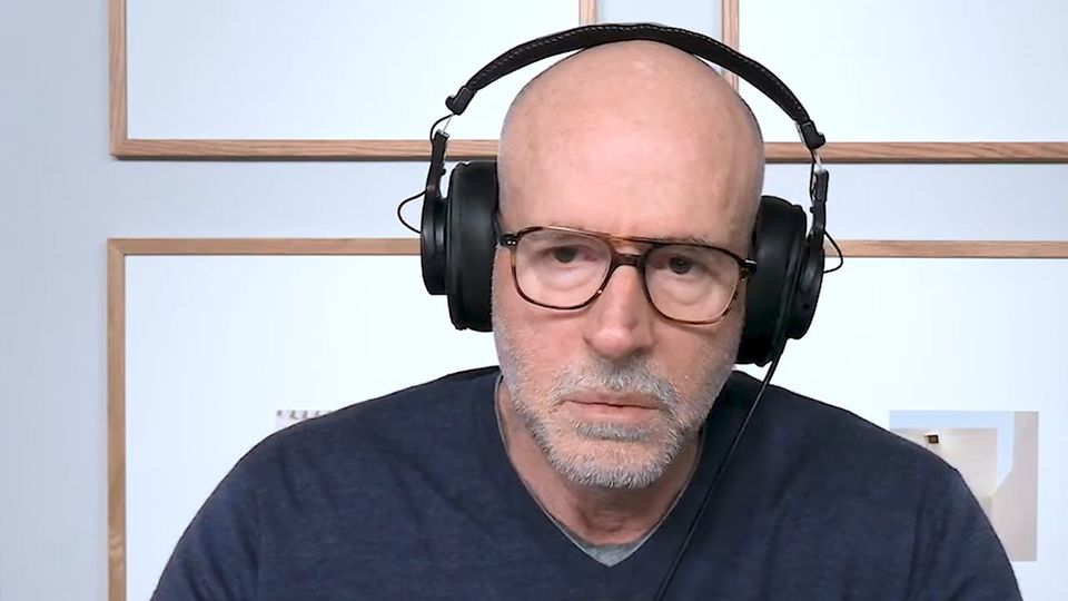 Bald, bespectacled, built (the three B's), Scott Galloway holding forth about business and whatnot in big black headphones.