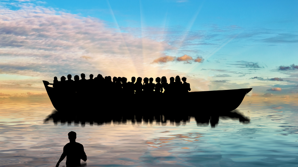 Silhouette of a ship on the water loaded with people but with space for more, set against streaks of sunlight over the sea. A lone figure in foreground is missing out.