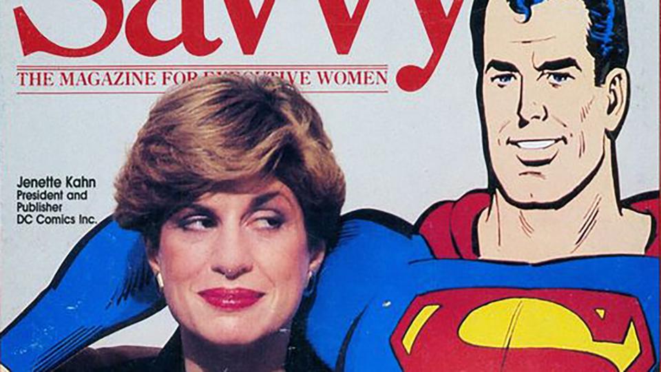 Detail of SAVVY magazine cover with Kahn looking side-eye at a big cardboard Superman. Full image below