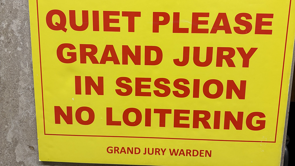 Sign in courthouse: QUIET PLEASE GRAND JURY IN SESSION NO LOITERING — GRAND JURY WARDEN
