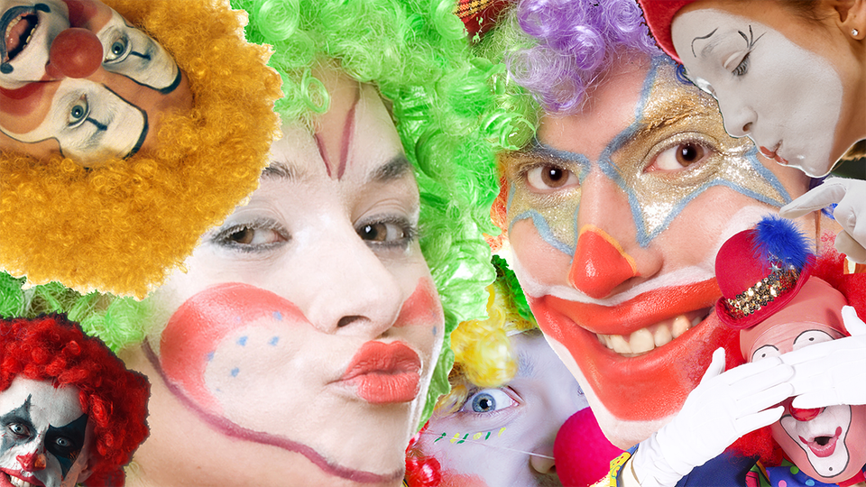 A bunch of clowns in wacky wigs and funny hats and creepy facepaint.