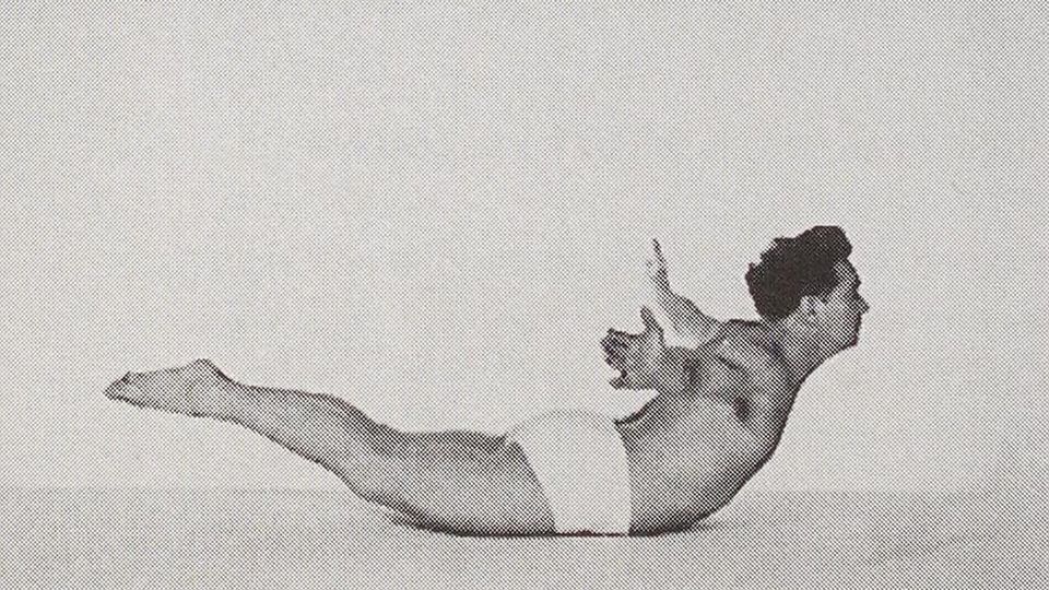 The author in a cobra-ish pose, wearing white trunks, arms stretched wide