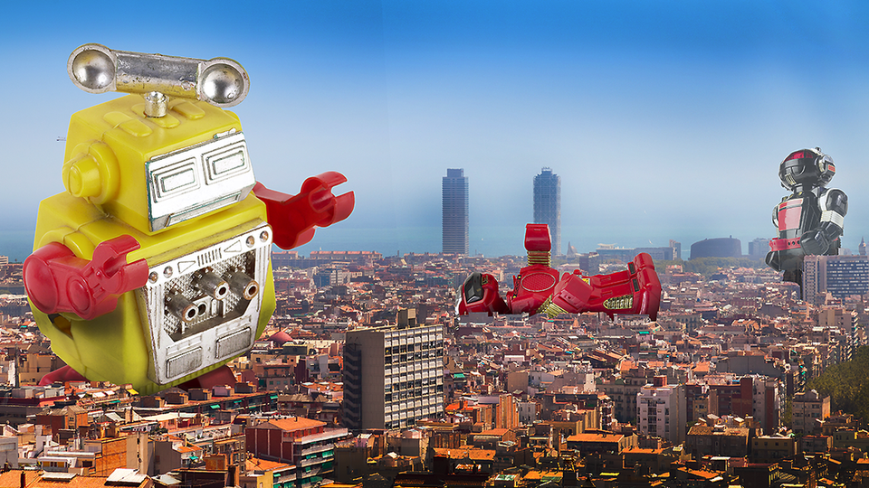 Giant robots in a cityscape; one of them is on its back