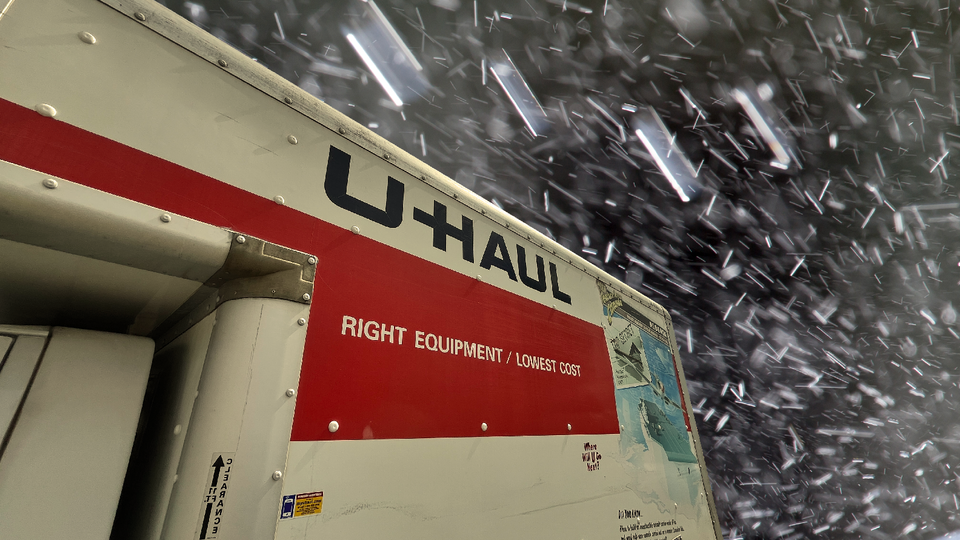 Detail of a U-Haul truck seen from the side in a hailstorm