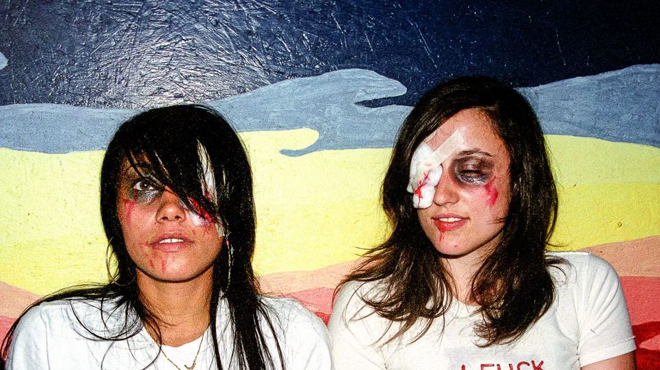 Two young women wearing fake blood and fake black eyes at a goth party in 2004