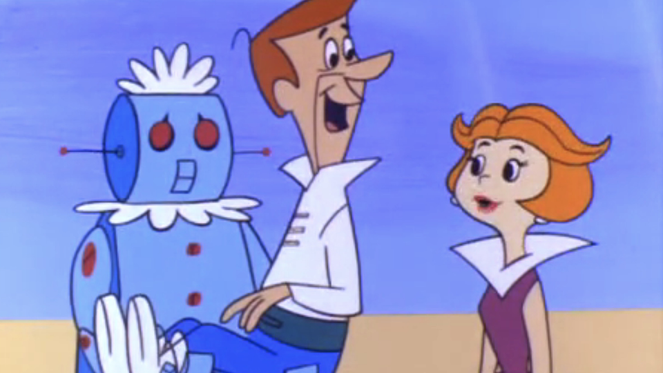 Rosey the Robot carries paterfamilias George Jetson into the family future-dwelling to greet Jane, his wife.