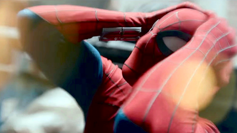 Spider-Man appears to be in some sort of distress holding his hands to the top of his masked head.