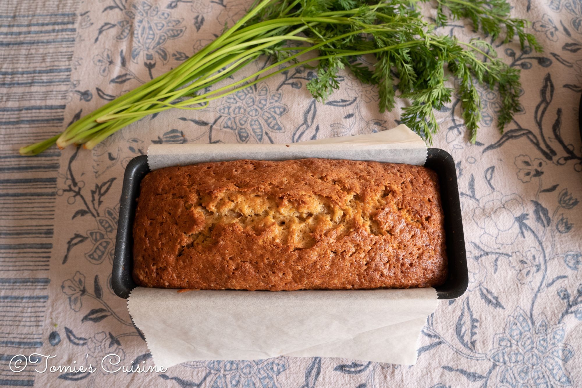 The cake, fresh out from the oven. Above is the carrot stem and leaves from the carrots we used.