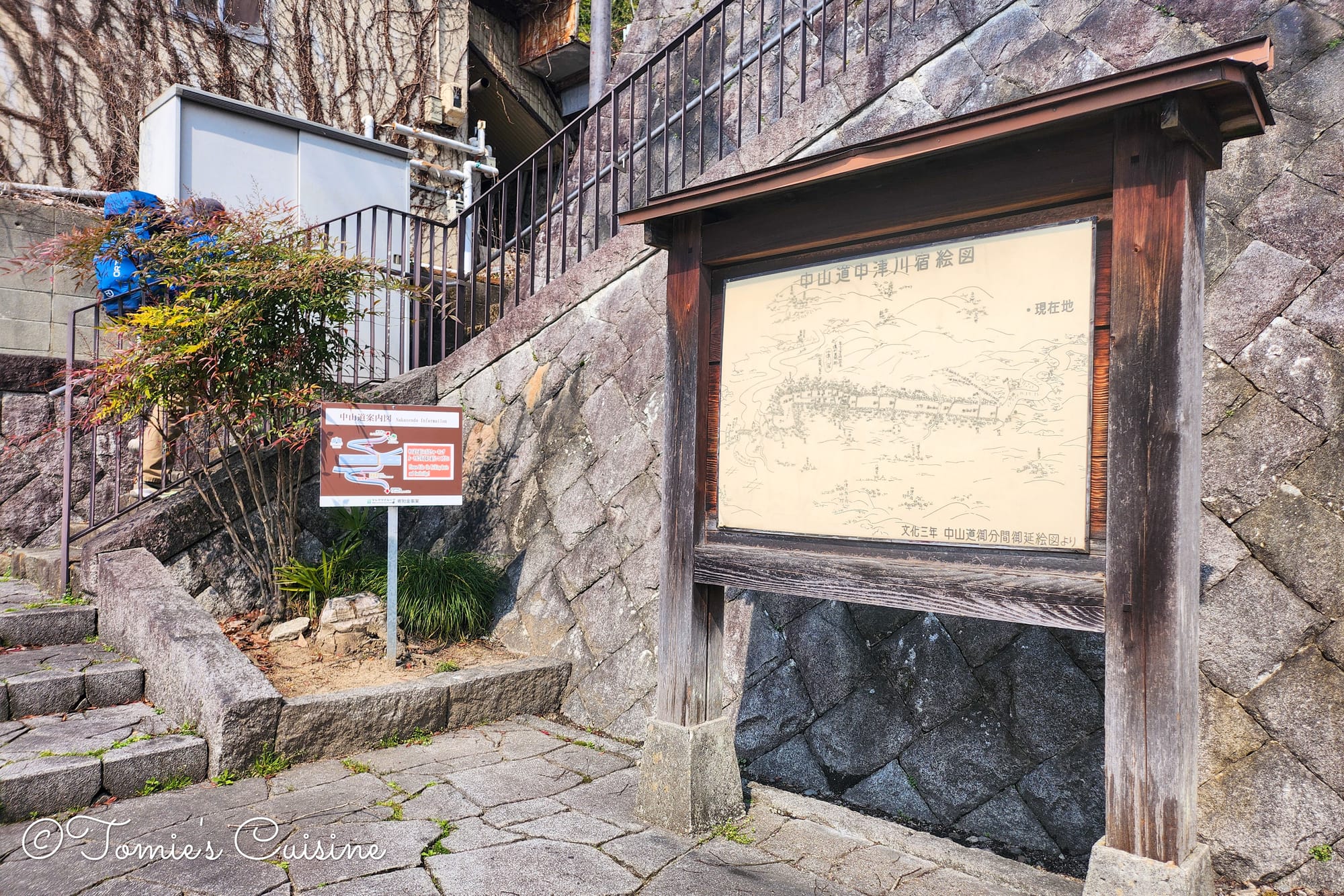 Old map of Nakatsugawa post town on a wooden board by stone steps