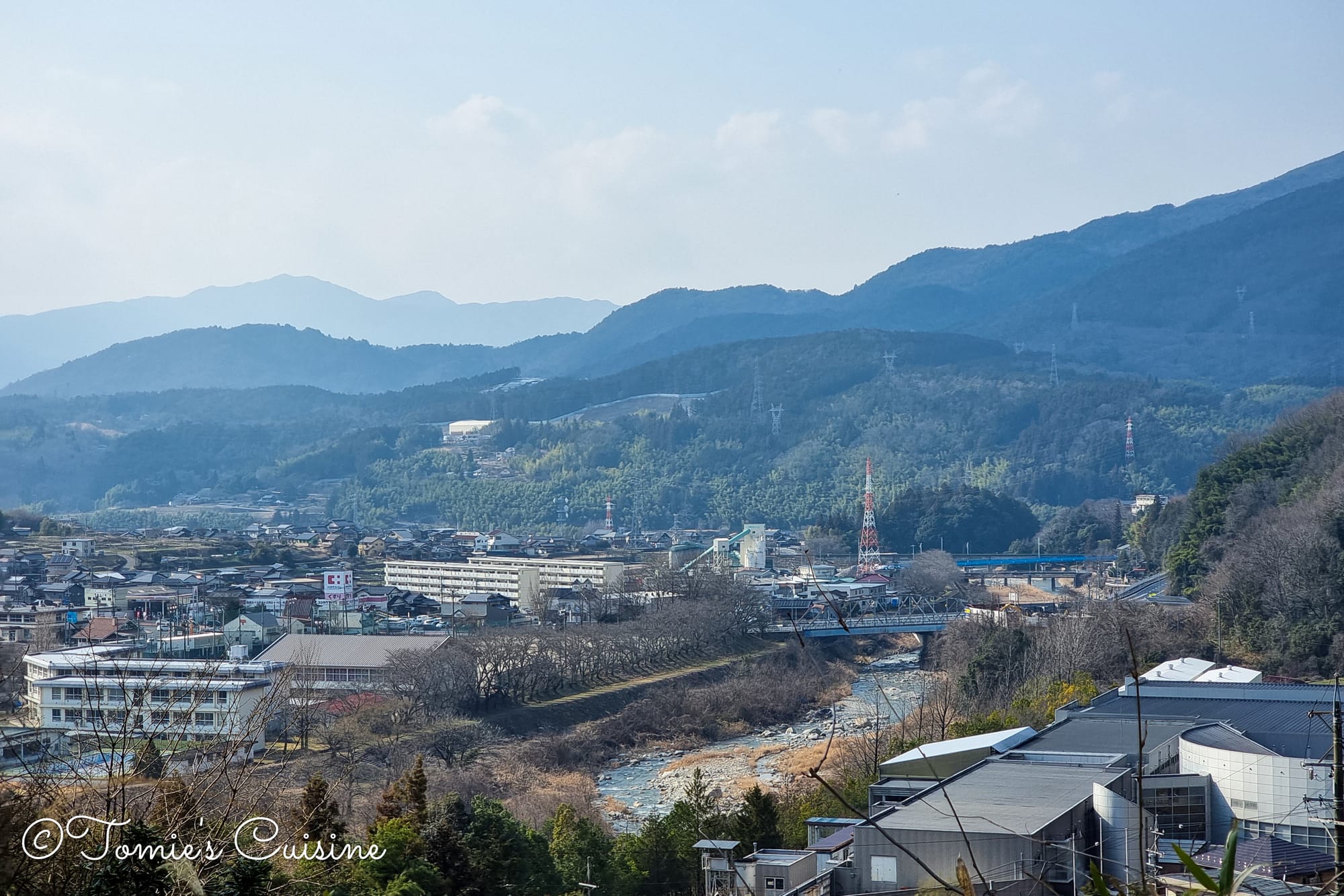 View down over the town and the mountains from the slope above the Ochiai River