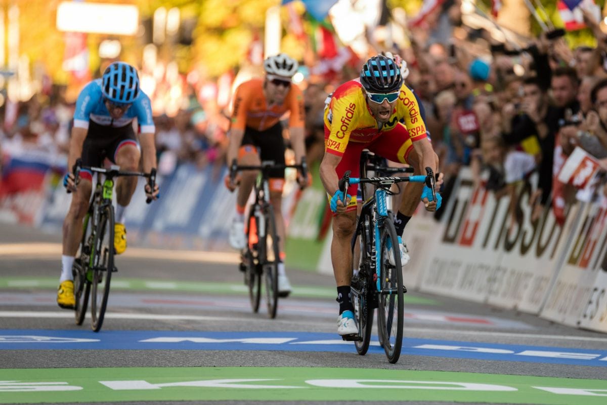 three cyclists racing on a competition