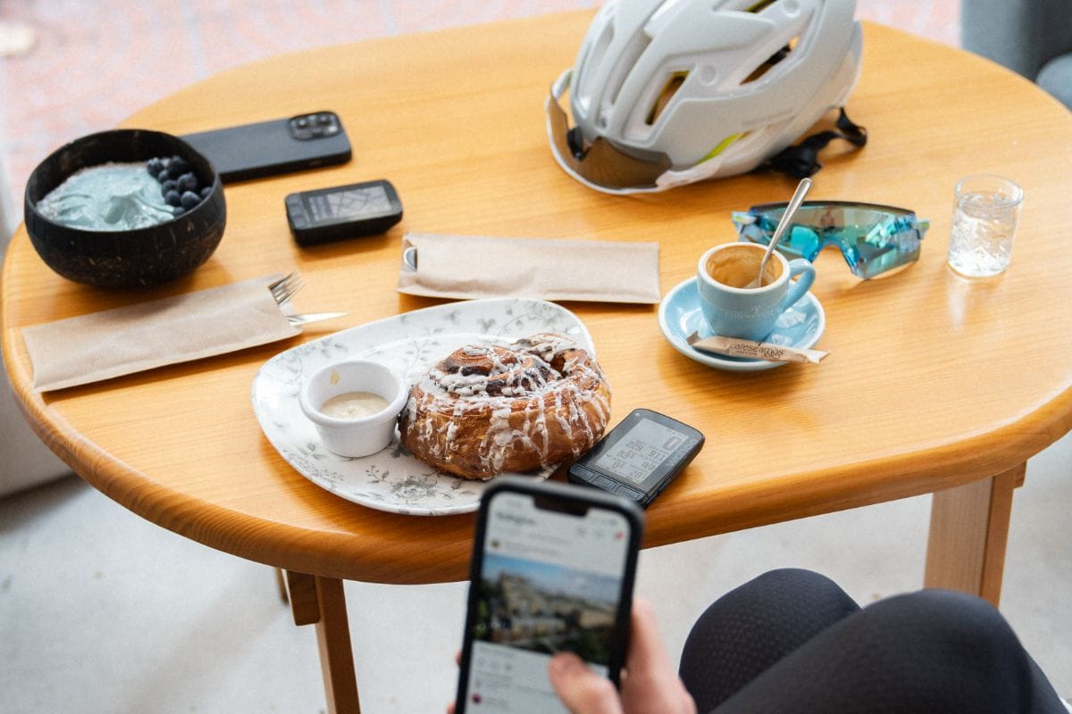 A shot of cyclists at a cycling friendly café, enjoying coffee and food.