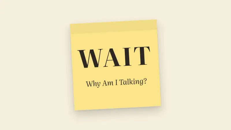 A yellow Post-it note reading WAIT – Why Am I Talking?