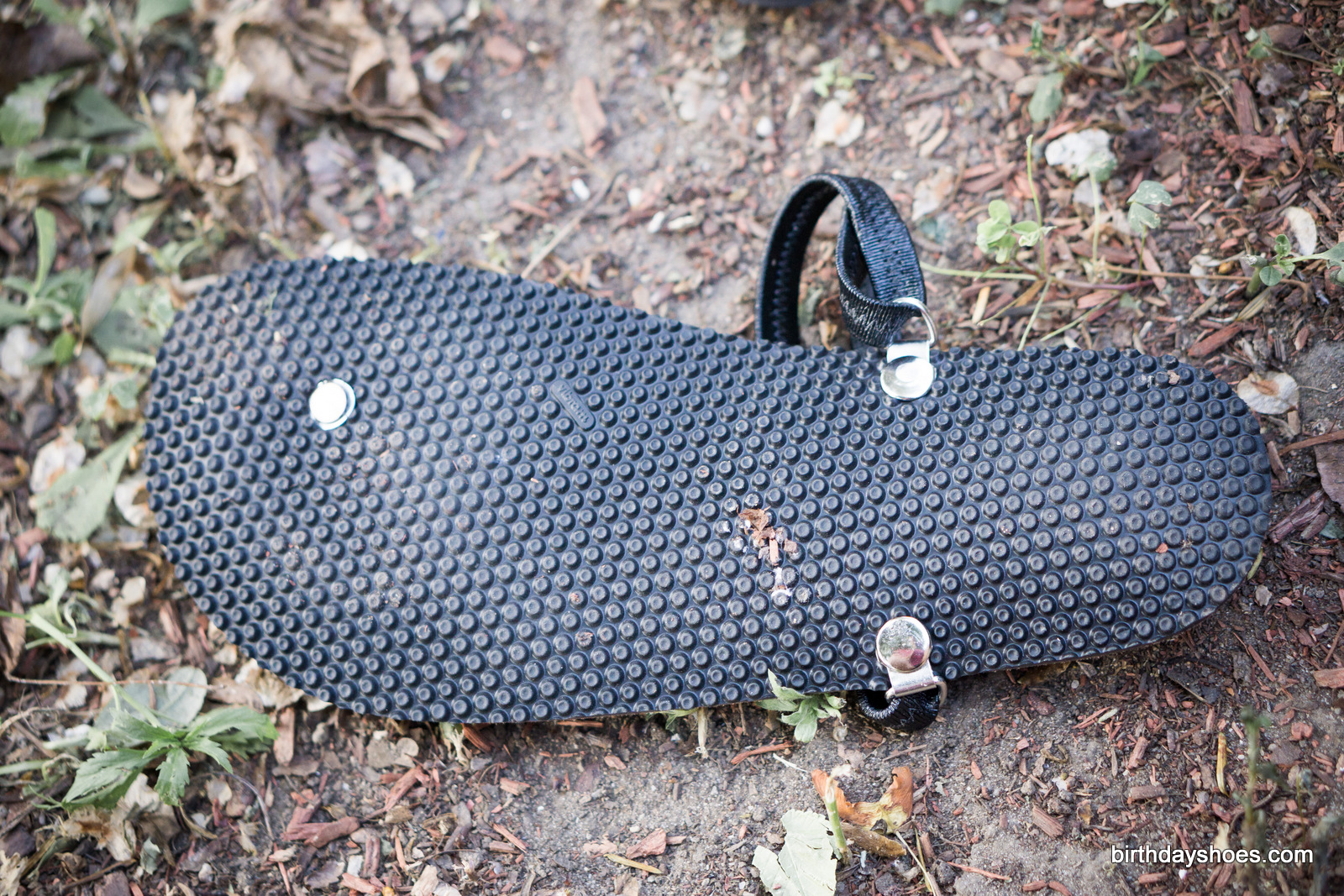 The small nubby points in the sole grips dirt and debris, sticks to wet rocks, but is smooth enough for roads