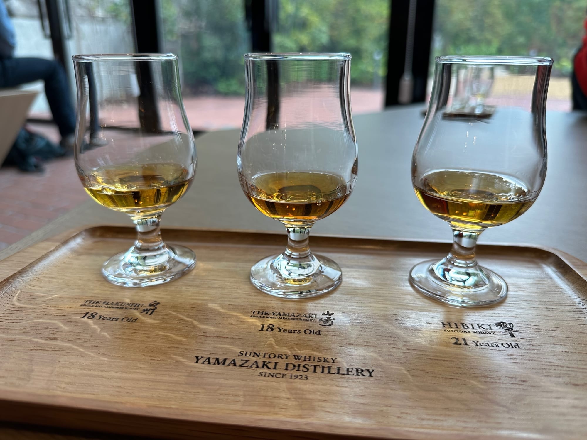 A tasting tray from Yamazaki Distillery with three glasses holding a sample of whiskey.