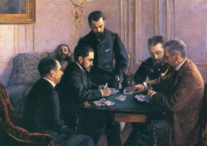 Two men in nineteenth-century play a card game at a small table as two other men look on, and a fifth sleeps on a nearby couch.