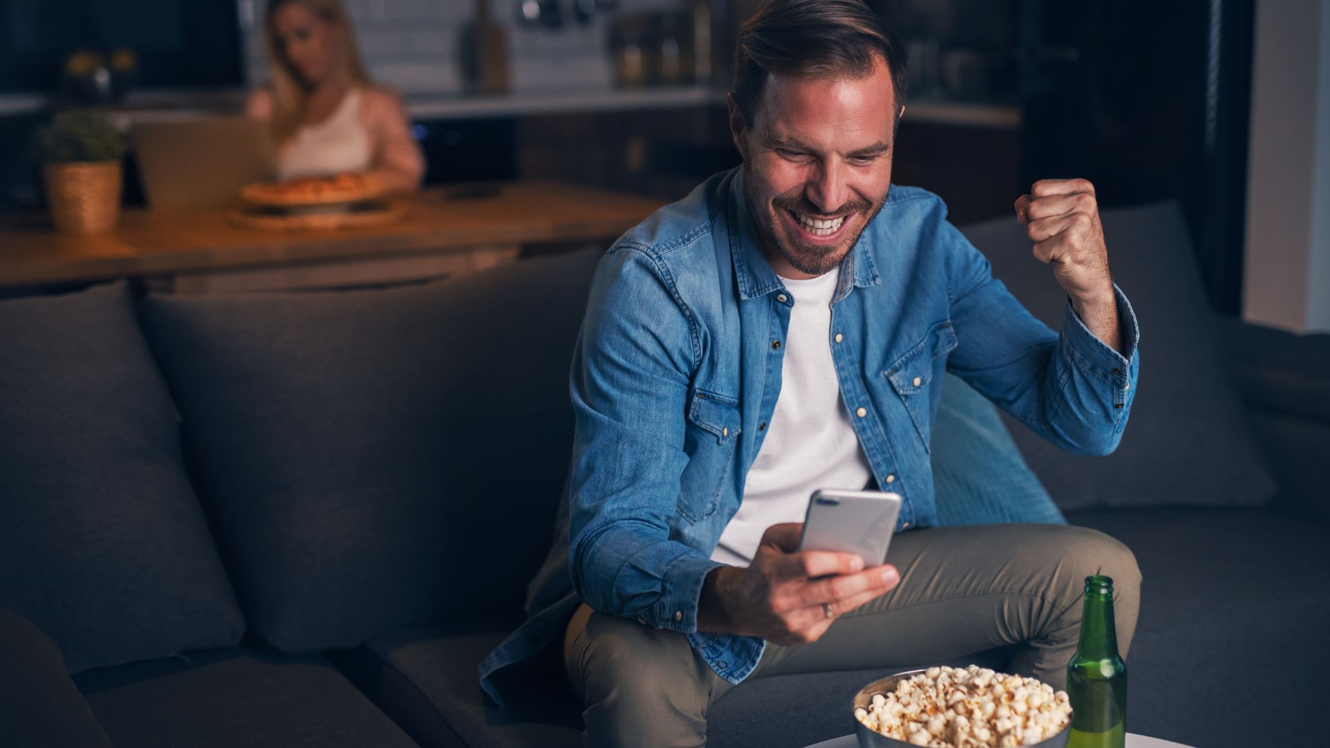 man celebrating a win after betting against the spread online