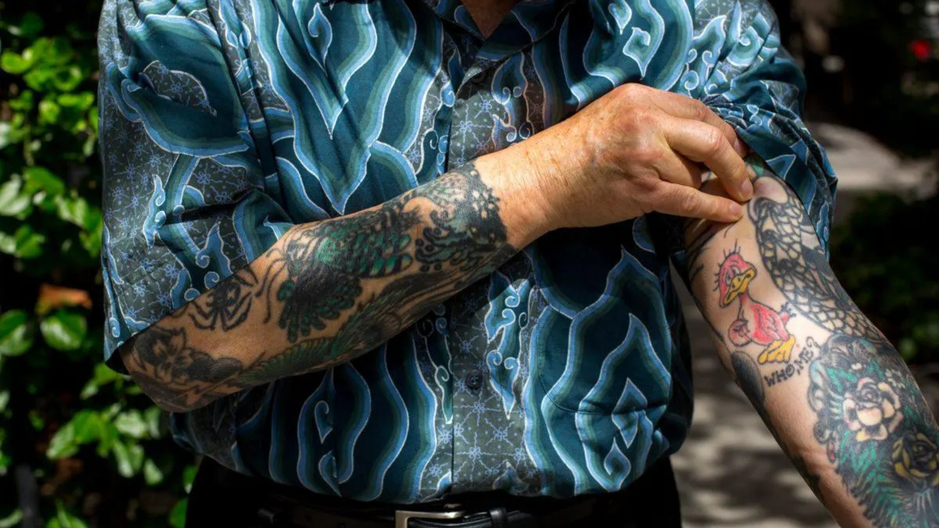 Ed Hardy showing of the Sailor Jerry designs on his arm