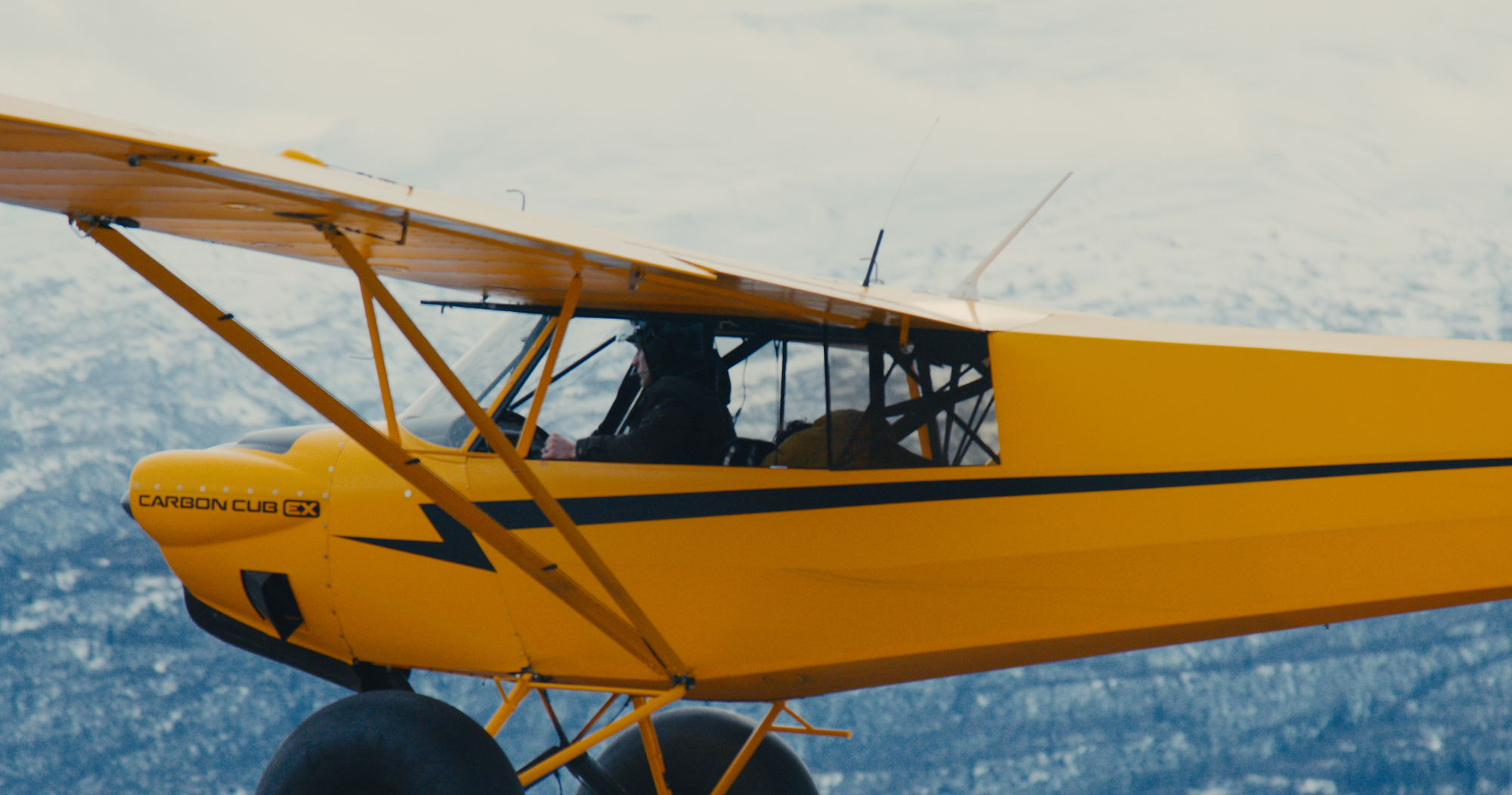 Brian Iles flying yellow airplane